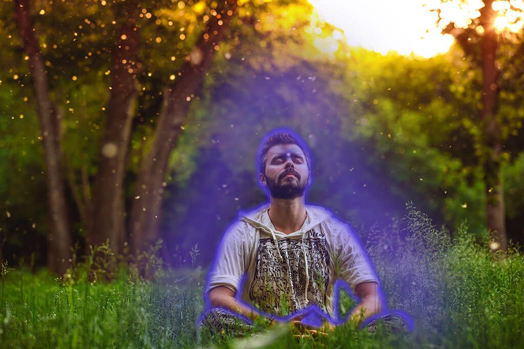 A man meditates on his indigo aura